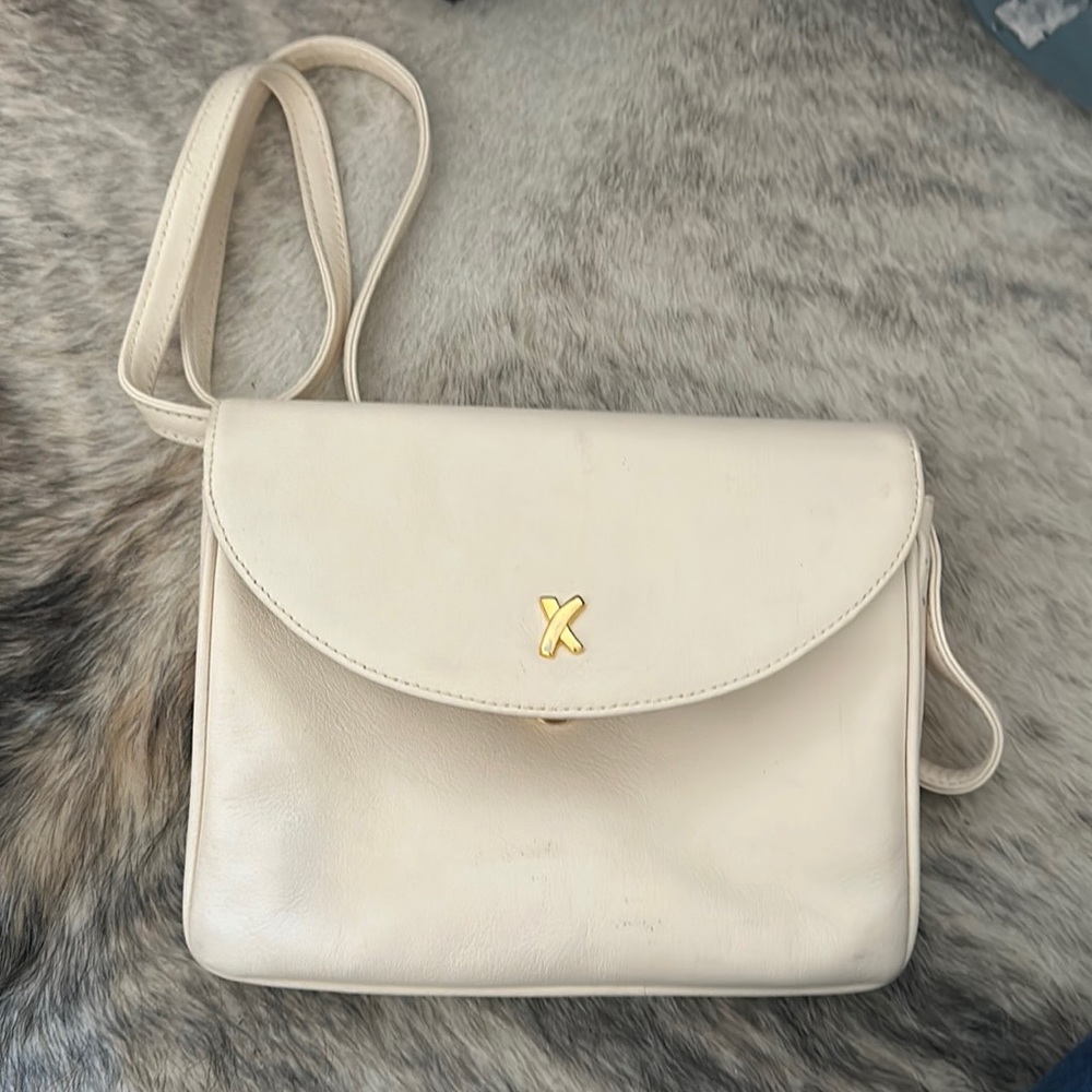 Super elegant bag By Paloma Picasso. Cream with a magnetic closure.